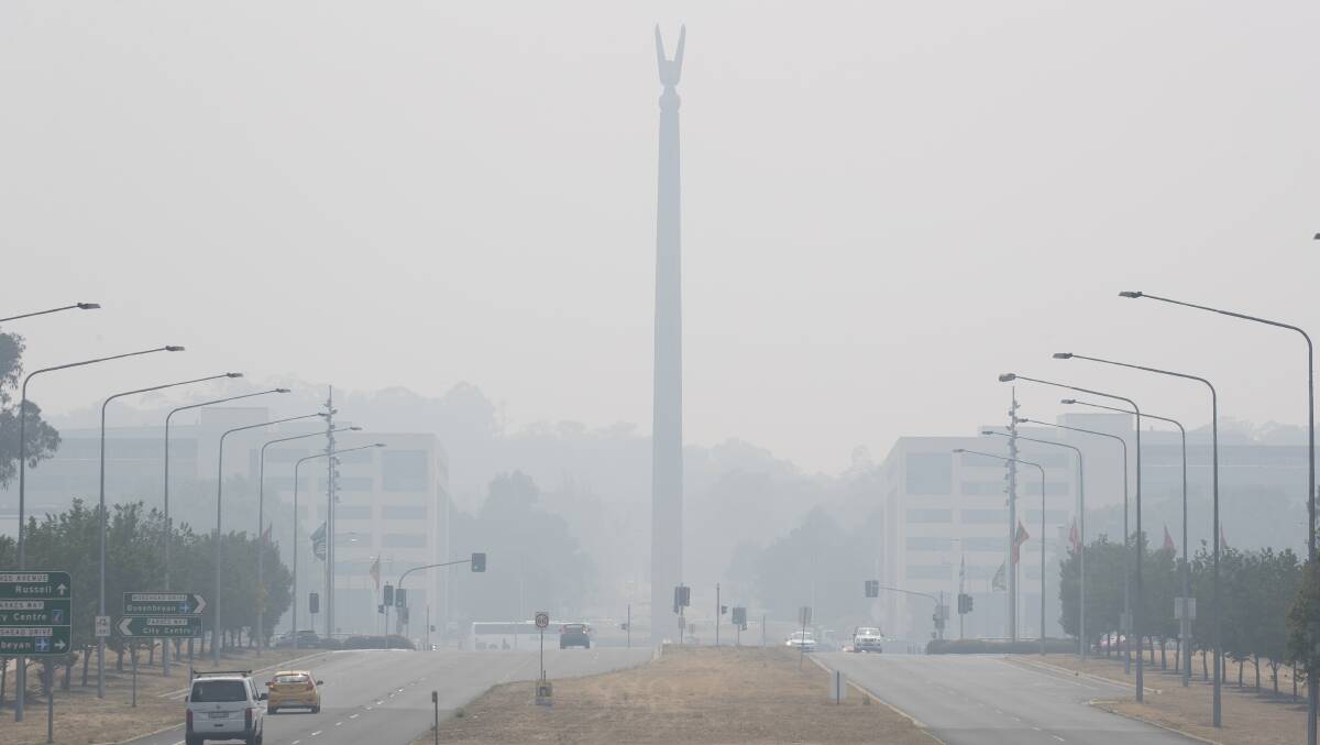 The Australian-American Memorial is silhouetted in smoke haze on Monday morning. Picture: Sitthixay Ditthavong