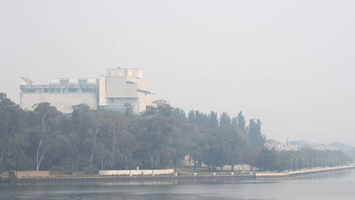 The High Court of Australia seen through smoke haze on Monday morning. Picture: Sitthixay Ditthavong