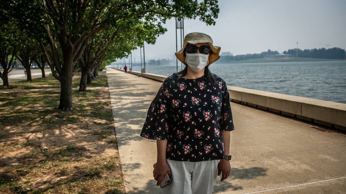 Julie Chen bought a mask on her way into work after hearing the health warnings while travelling on the bus. Picture: Karleen Minney