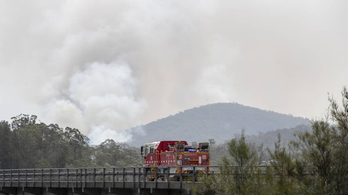 Victorian Country Fire Authority crews rush over the Nelligen bridge towards plumes of smoke north of Nelligen on Tuesday afternoon. Picture: Sitthixay Ditthavong