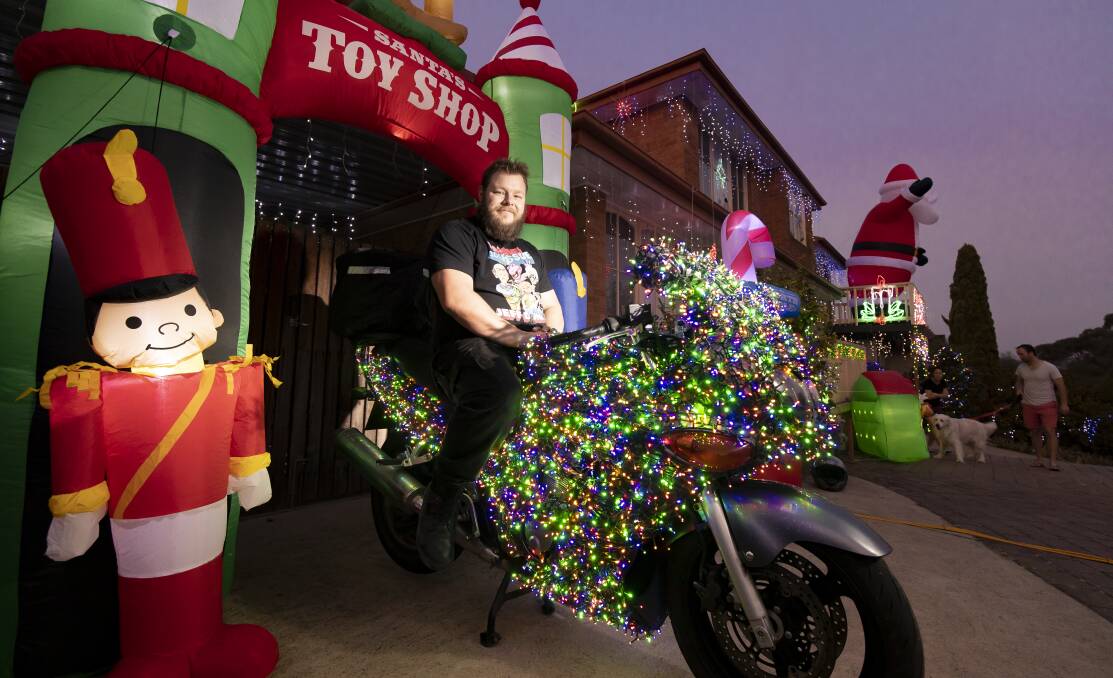 Stuart Murphy and his Christmas bike in Fisher on Wednesday night. Picture: Sitthixay Ditthavong