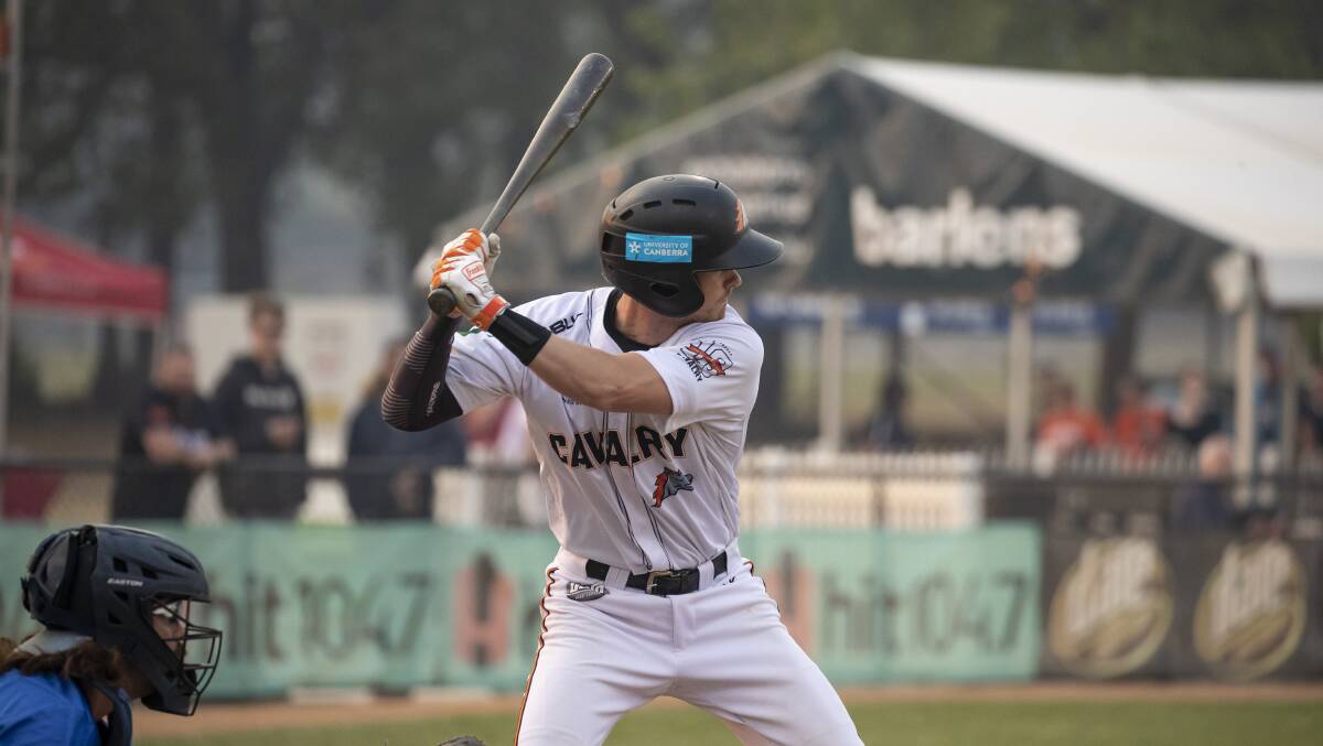 Canberra Cavalry's Cam Warner bats through the smoke. Picture: Sitthixay Ditthavong