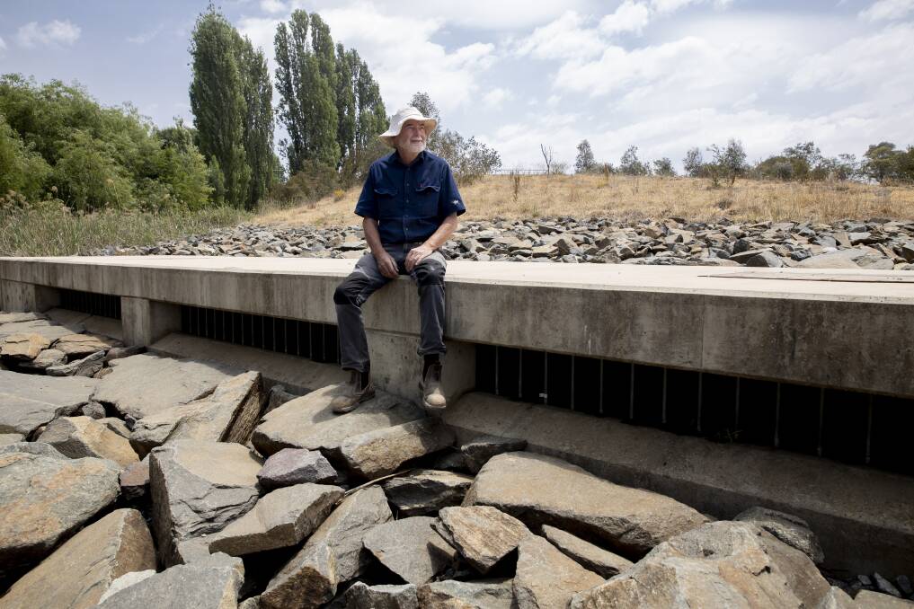 Burra resident Chris Devitt sits at the outlet of the Murrumbidgee to Googong pipeline. Picture: Sitthixay Ditthavong