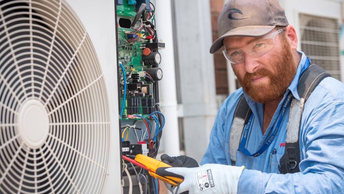 Fredon airconditioning technician Ben Caldwell checks a unit during a busy summer. Picture: Karleen Minney