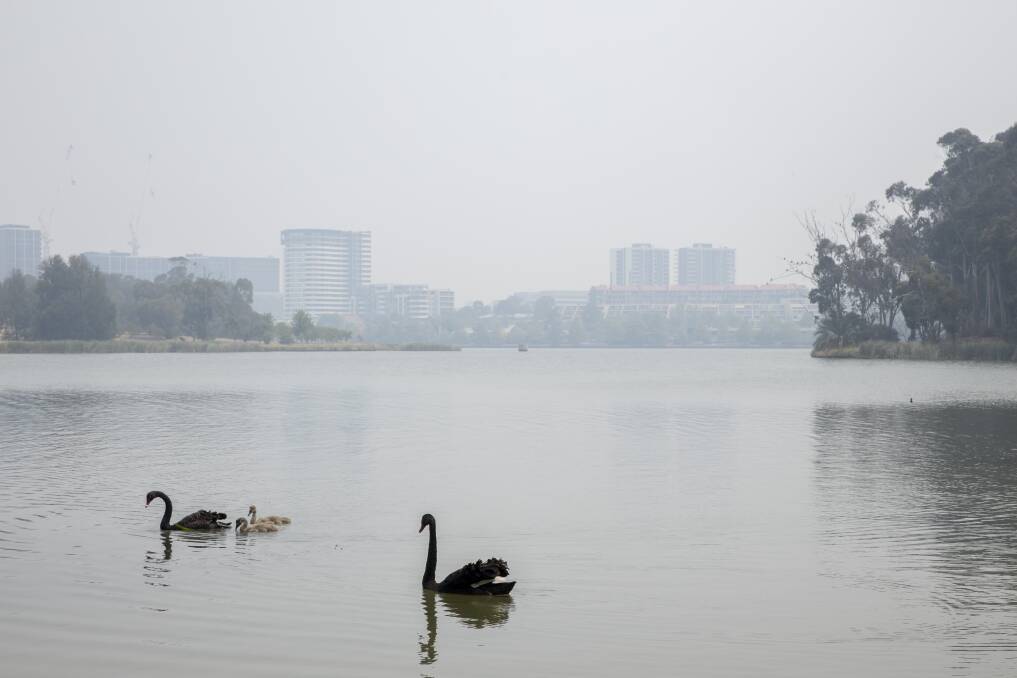 Smoke haze over Lake Ginninderra on Christmas Eve. Picture: Sitthixay Ditthavong