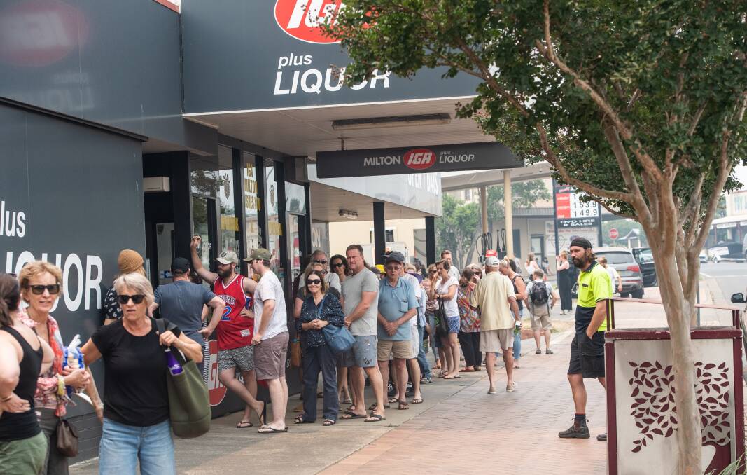Long queues form at the Milton IGA where shoppers could only purchase six items at once. Picture: Karleen Minney