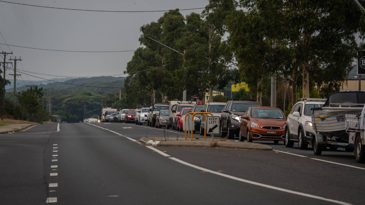 Kilometres of cars queue to refuel and leave the South Coast via Ulladulla after official warnings to get out before the weekend. Picture: Karleen Minney