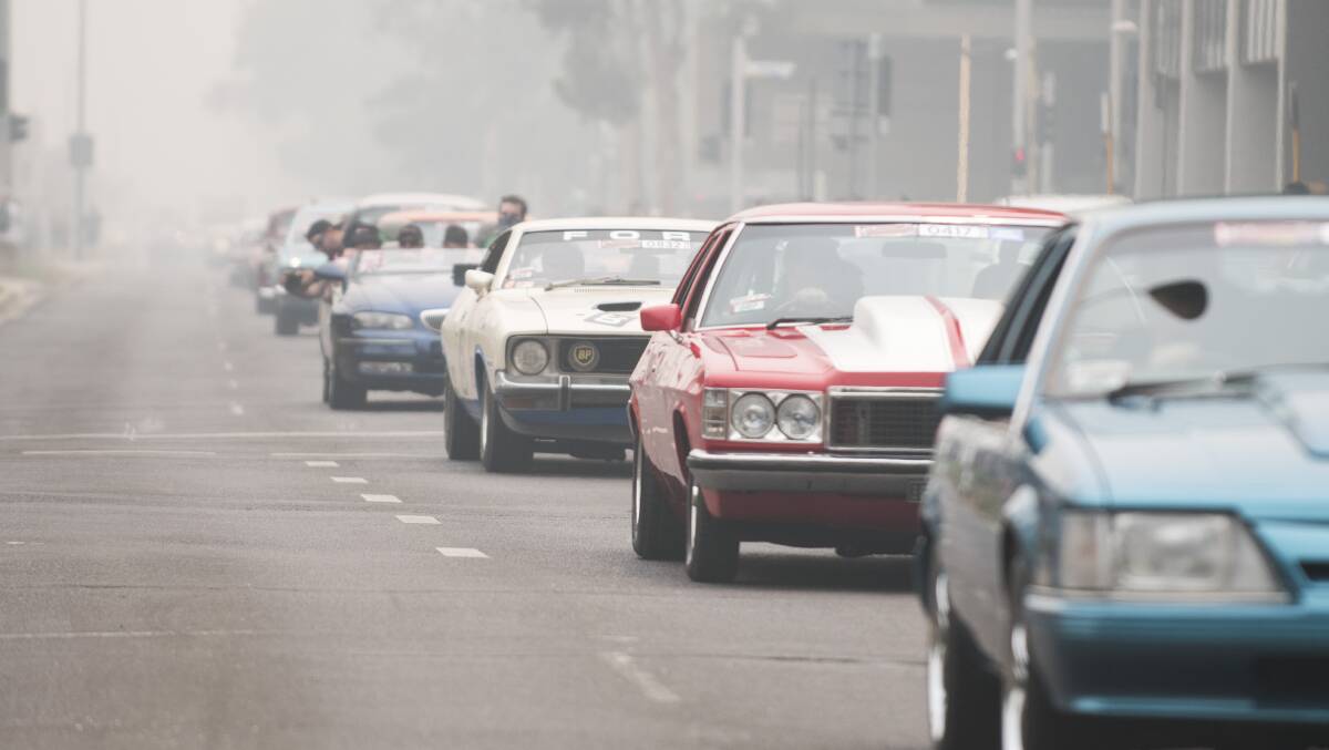 Flashback to January 2020, with the Summernats City Cruise entrants rolling through the bushfire smoke. Picture: Dion Georgopoulos