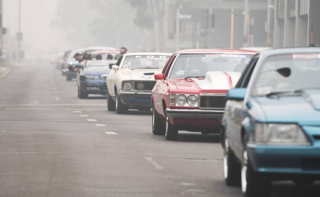 The Summernats City Cruise last year, with bushfire smoke swirling around the city. Picture: Dion Georgopoulos