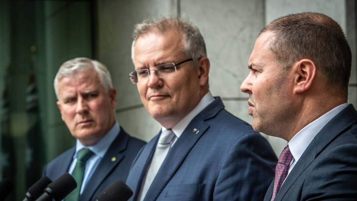 Prime Minister Scott Morrison (centre) with Nationals leader Michael McCormack (left) and Treasurer Josh Frydenberg. Picture: Karleen Minney