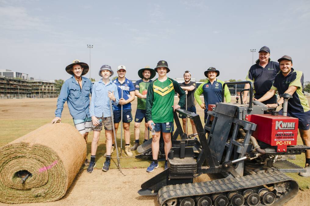 Raiders staff and family lay the turf at their new training base, including chief executive Don Furner (left), his son Ryan, Jackson Stuart, Ben Pollock, Lachlan Ford, Tom Logan, Matt Ford, Mathew Woolfe and Nick Bauld. Picture: Jamila Toderas