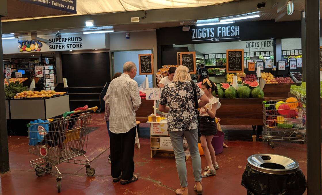 Shoppers in Belconnen gathering to buy a lemonade in support of the NSW Rural Fire Service.