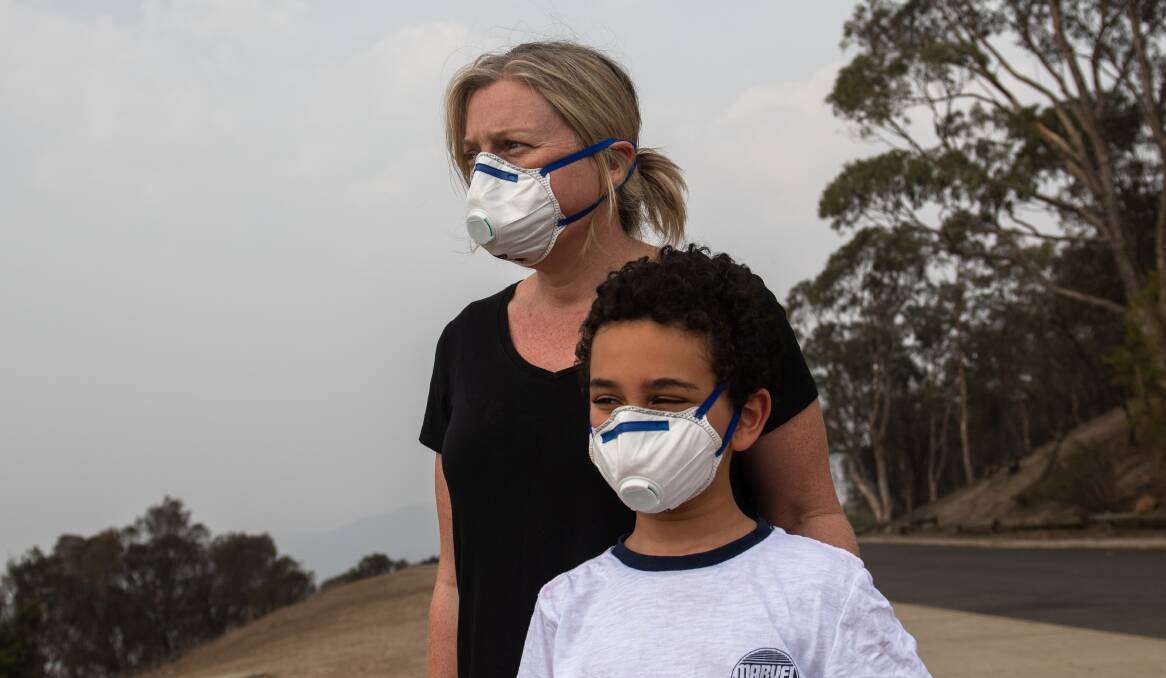 Michelle Daly and her son Liam wearing P2 mask on Mt Ainslie. Picture: Elesa Kurtz