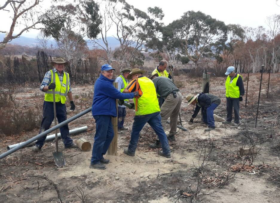 BlazeAid volunteers work to restore bushfire-damaged fences near Braidwood on Friday. Picture: Supplied