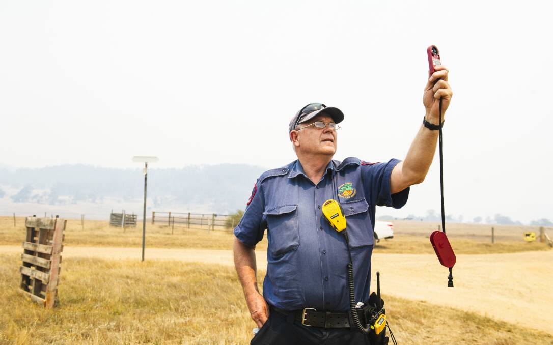 Alan Ashman, from the ACT Gungahlin RFS Brigade, conducts a weather check. Picture: Dion Georgopoulos