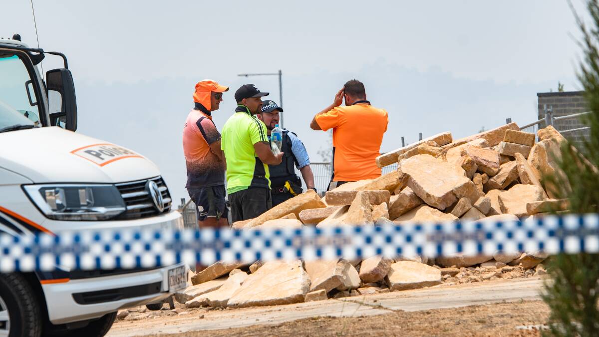 Workers with police at worksite death on Ada Norris Avenue Denman Prospect on Saturday. Picture: Elesa Kurtz