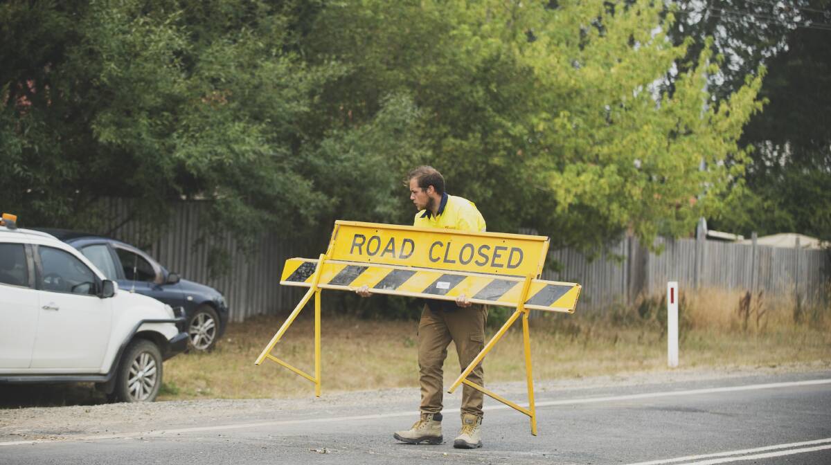 A council worker removes the sign stopping motorists from driving on the Kings Highway. Picture: Dion Georgopoulos