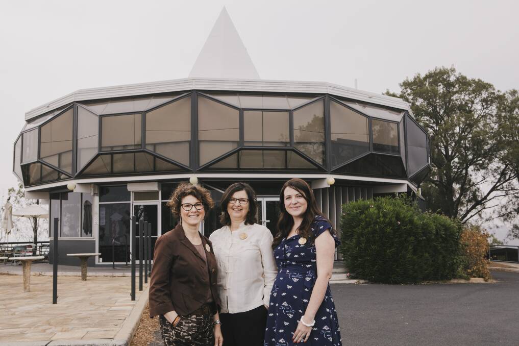 Canberra Modern's Edwina Jans, Rachel Jackson, and Amy Jarvis at Red Hill lookout. Jackson will be presenting a talk on Canberra's architecture as part of Palm Springs' Modernism Week. Picture: Jamila Toderas