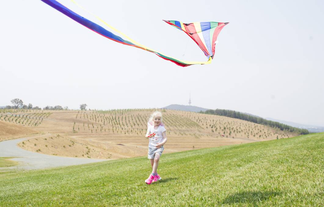 Willow Wiseman, 4, flying a kite she was given as a Christmas present for the first time at the National Aboretum on Saturday. Picture: Dion Georgopoulos