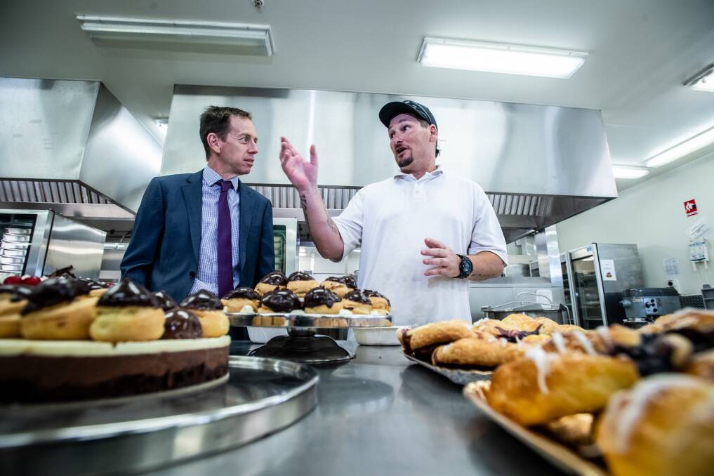 Alexander Maconochie Centre detainee Paul Blundell explains the jail's kitchen procedures to ACT Justice Minister Shane Rattenbury. Picture: Karleen Minney