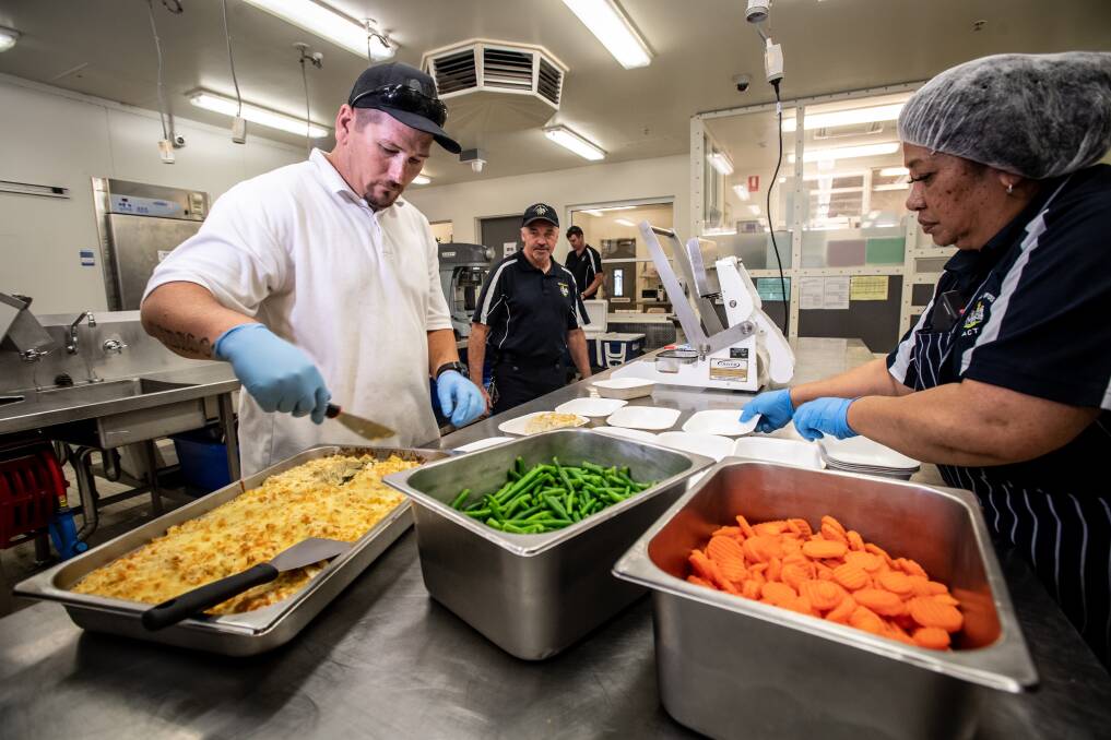 Paul Blundell (left) is among about a dozen detainees helping prepare meals for air crews. Picture: Karleen Minney