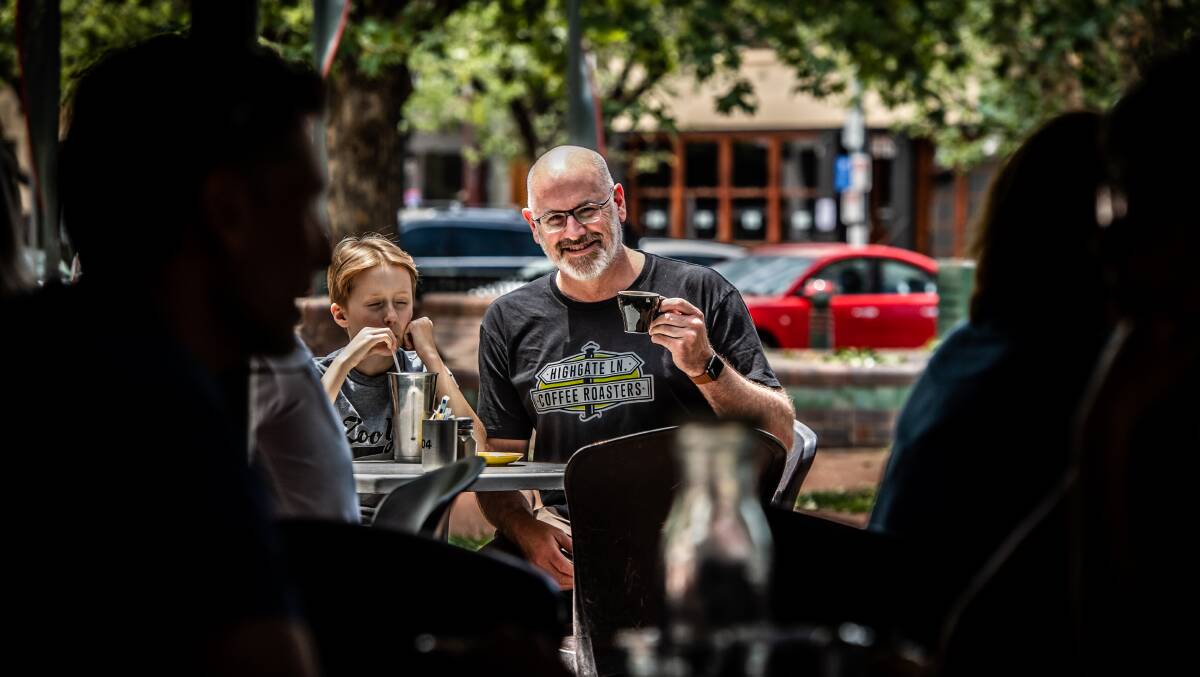 Bittersweet cafe's Dan Rayner, pictured with son Luka, has welcomed the ACT government's decision to slash outdoor dining fees. Picture: Karleen Minney