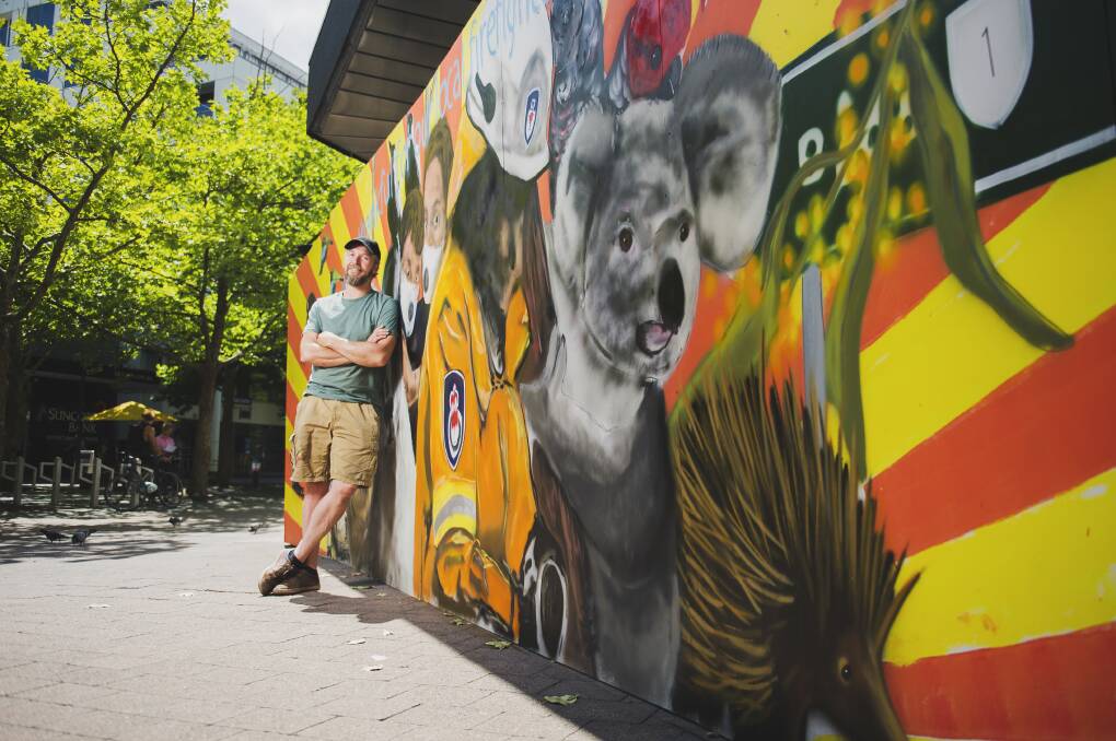 Geoff Filmer stands next to the mural he painted at Civic to say thank you to firefighters. Picture: Dion Georgopoulos