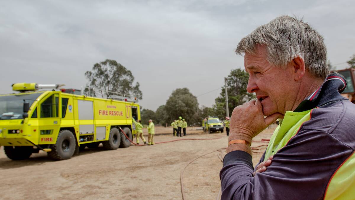 Duntroon Dairy owner, Gary Brodrick, watching on as firefighters work on blaze on his property. Picture: Elesa Kurtz
