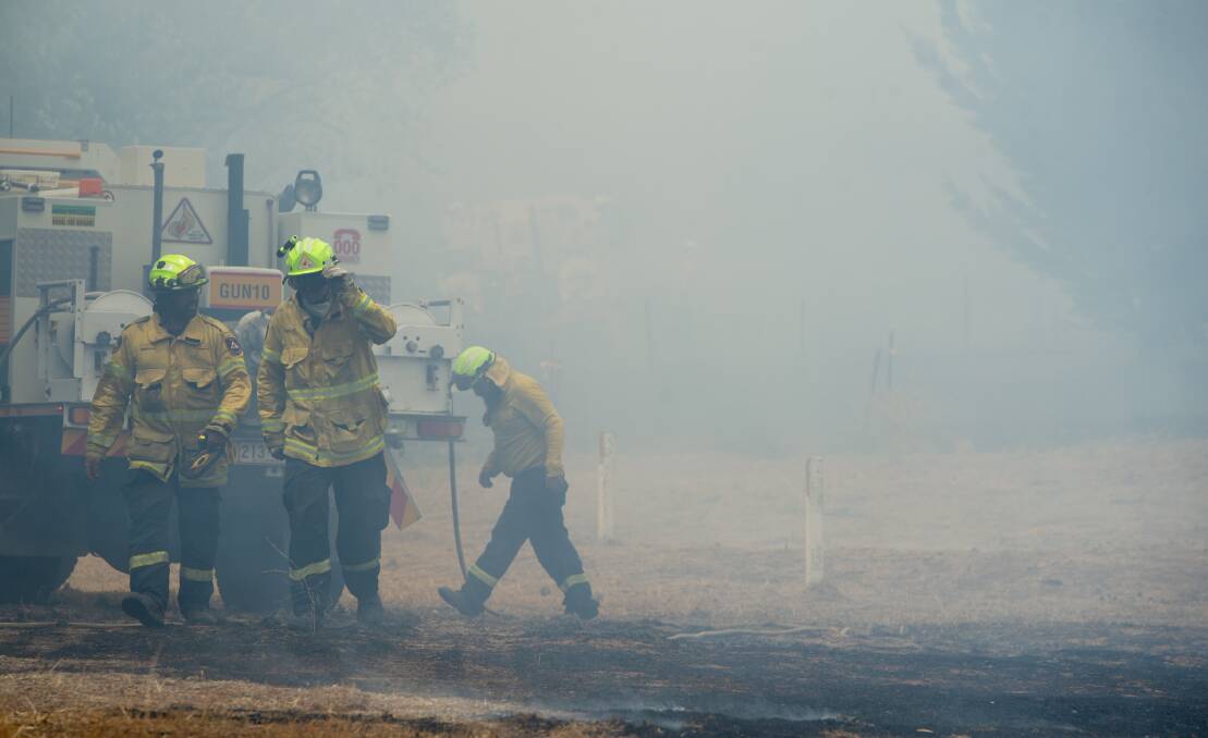 Firefighters work on fire near Pialligo Road. Picture: Elesa Kurtz