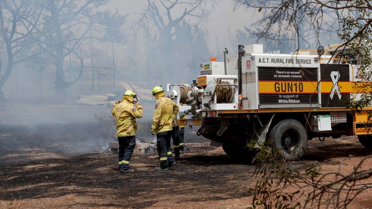 Firefighters work on the fire near Pialligo Road on January 23 when Canberra Airport was closed. Picture: Elesa Kurtz