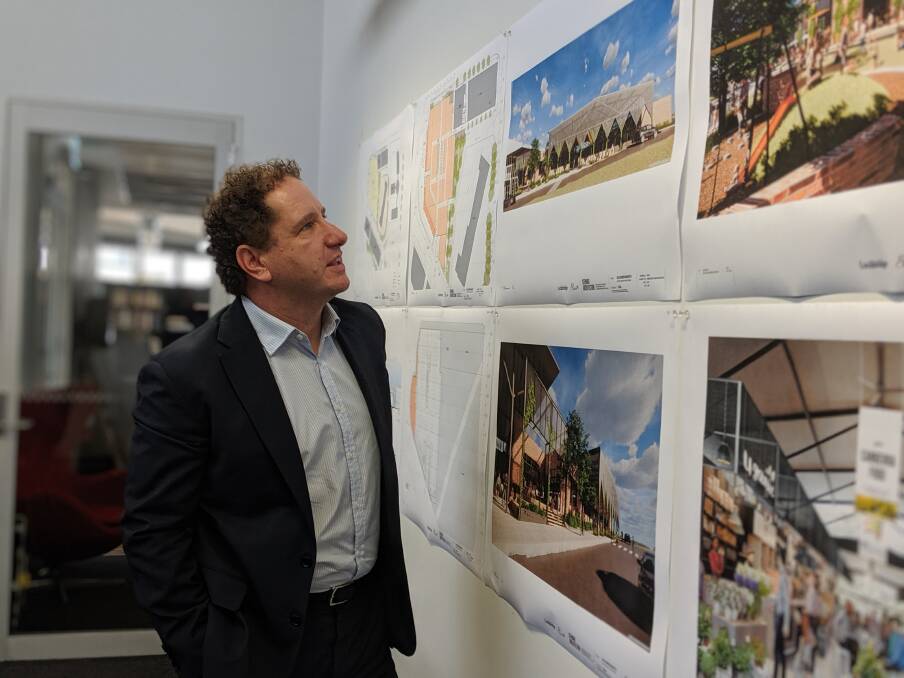 Elanor head of real estate Michael Baliva with the plans for the new Belconnen markets.