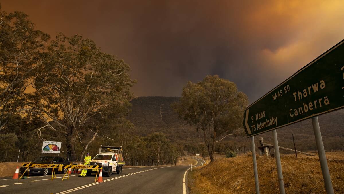 A road block outside Namadgi National Park visitor centre the day after the Orroral Valley fire began. Picture: Sitthixay Ditthavong