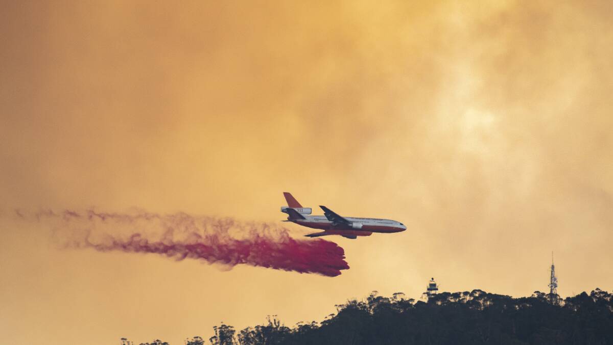 Fire retardant is dropped on Mt Tennent, south of Canberra, in January as a bushfire in Namadgi National Park reaches emergency level. Picture: Sitthixay Ditthavong