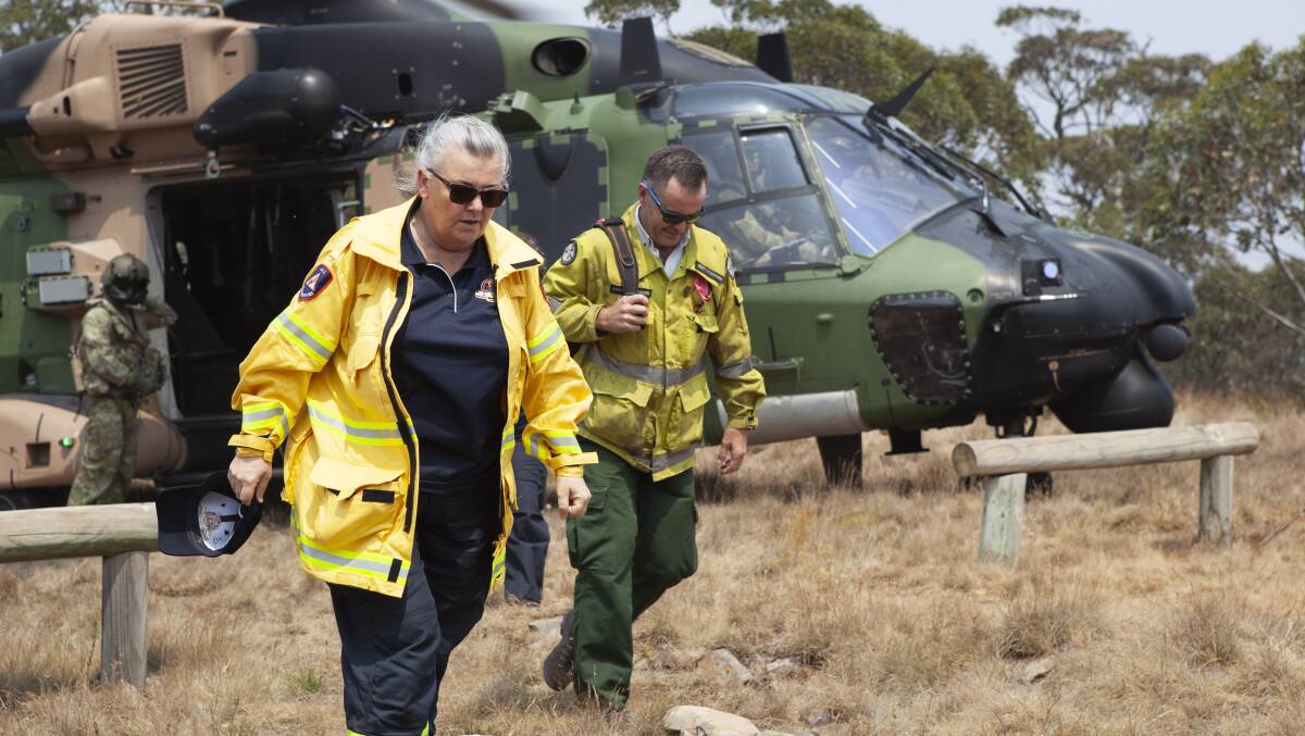 ACT Emergency Services Agency Commissioner, Georgeina Whelan and Namadgi National Park Area Manager Brett McNamara disembark from an MRH-90 Taipan helicopter at Mt Ginini. Picture: Department of Defence