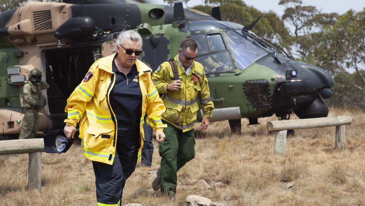 ACT Emergency Services Agency Commissioner, Georgeina Whelan and Namadgi National Park area manager Brett McNamara disembark from an MRH90 Taipan helicopter at Mt Ginini. Picture: Department of Defence