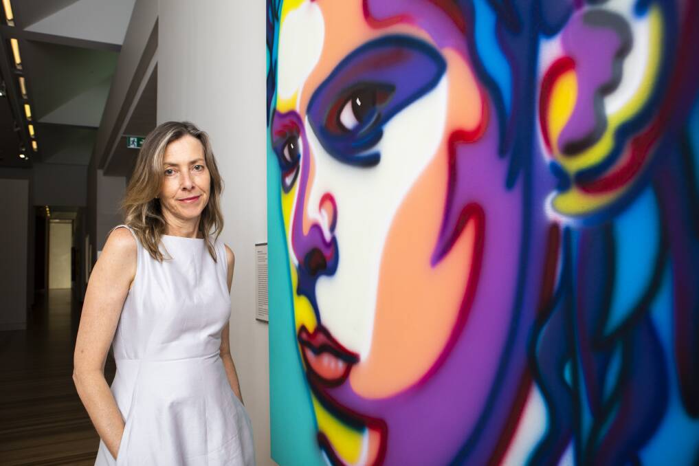 National Portrait Gallery director Karen Quinlan, with the art work she would be eager to save: Howard Arkley's iconic 1999 portrait of Nick Cave. Picture: Jamila Toderas