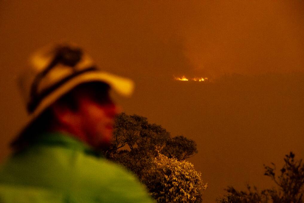 Brett Povey watches as the Clear Range fire approaches his property Glenroy in Colinton. Picture: Sitthixay Ditthavong