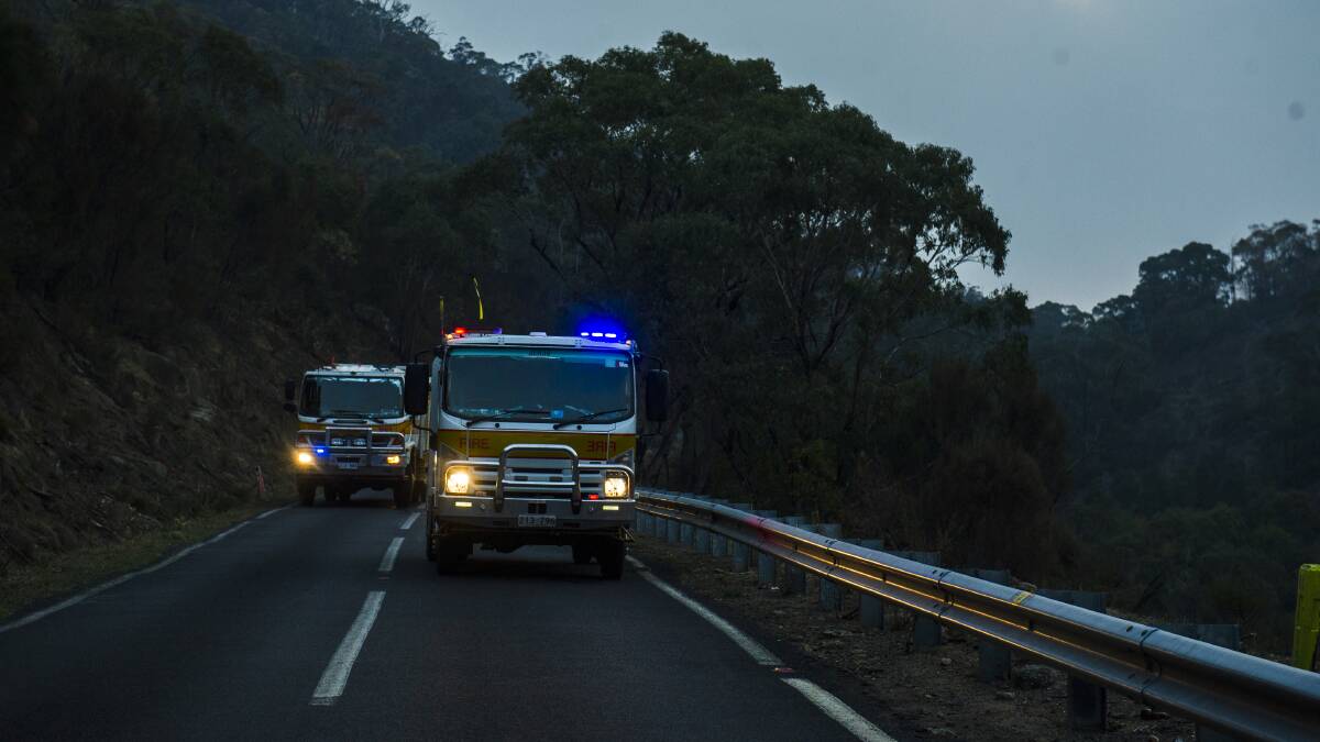 Firefighters on Naas Road, near Tharwa. Picture: Dion Georgopoulos