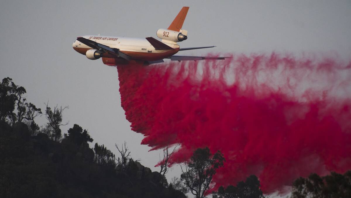 An air tanker drops fire retardant near Tharwa. Picture: Dion Georgopoulos