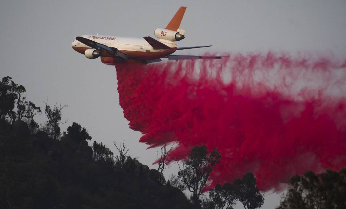 An air tanker drops fire retardant near Tharwa during the Orroral Valley bushfire. Picture: Dion Georgopoulos