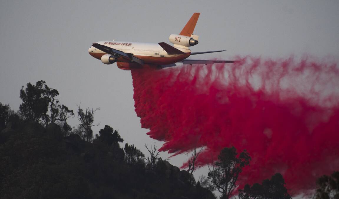 An air tanker drops fire retardant near Tharwa. Picture: Dion Georgopoulos