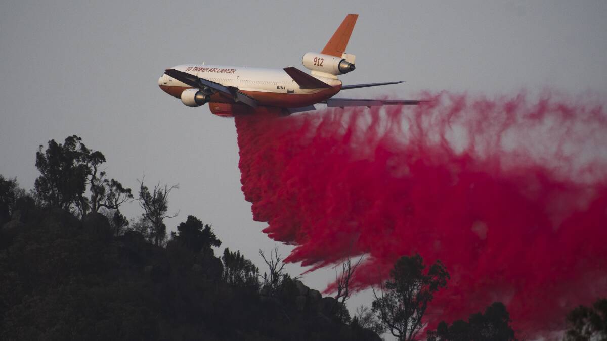 An air tanker drops fire retardant near Tharwa as seen from Naas Rd. Picture: Dion Georgopoulos