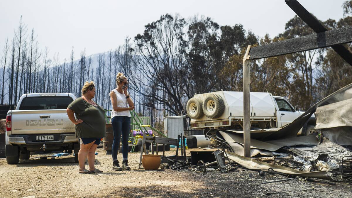 Neighbour Michelle O'Leary with Annika Safe, whose property in the Bumbalong Valley by fire on Saturday. Picture: Dion Georgopoulos