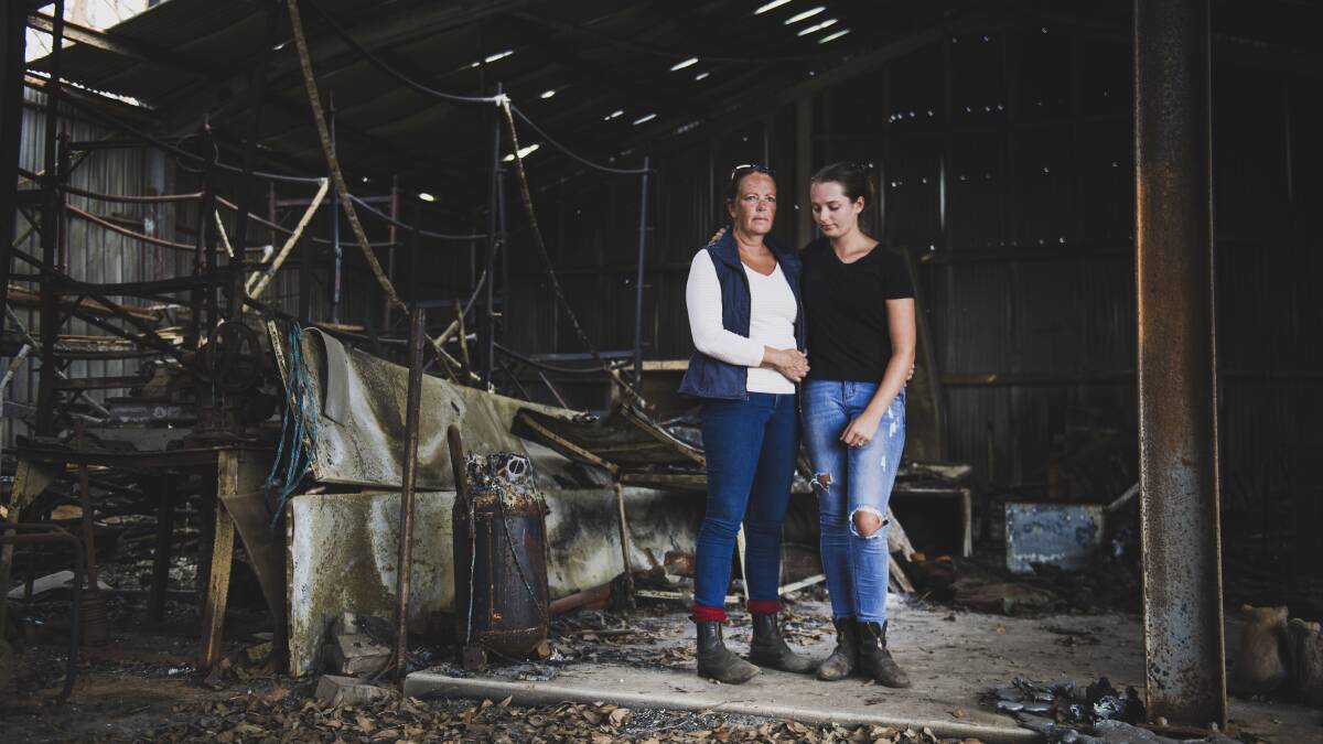 Libby Buttress and daughter Cara Earlam at their Longridge Equestrian Centre which was destroyed during the Clyde Mountain bushfire. Picture: Dion Georgopoulos