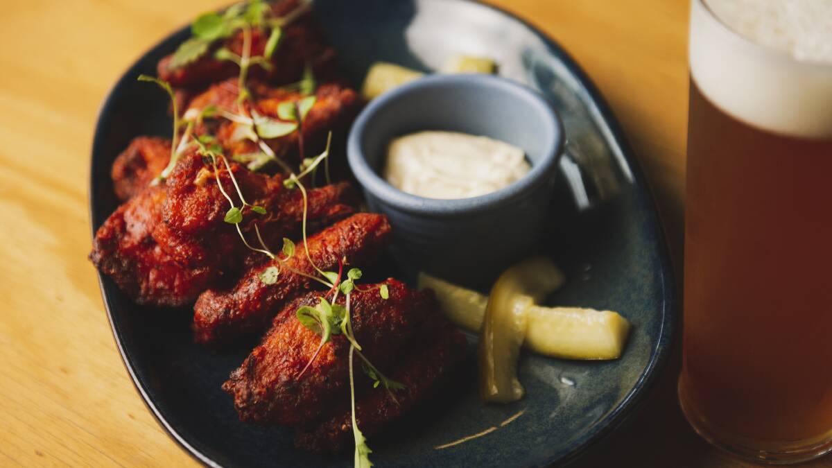 Grain-crusted hot wings coated in brewery-made sauce, served with malted blue cheese aioli and pickled cucumber. Picture: Dion Georgopoulos