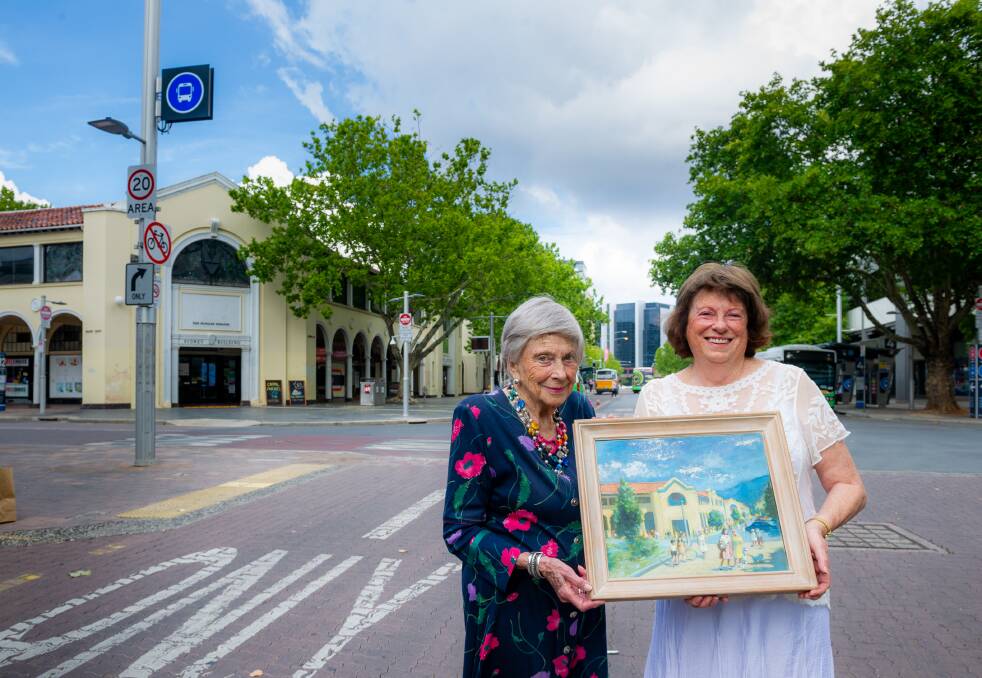 Dawn Waterhouse (nee Calthorpe) and daughter Jill Waterhouse, with a painting of the Sydney and Melbourne buildings. Picture: Elesa Kurtz.