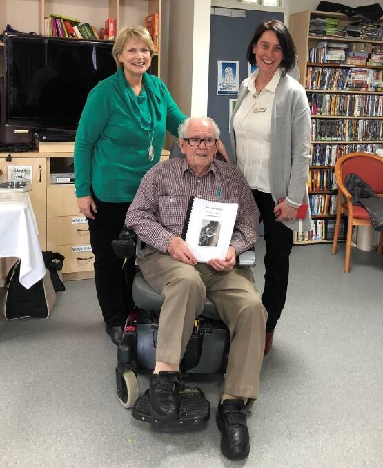 Life Stories participant John McGee, of Holt, at his "book launch", with Palliative Care ACT Life Stories volunteer Sarah Major (left) and coordinator Liz Rhodes.