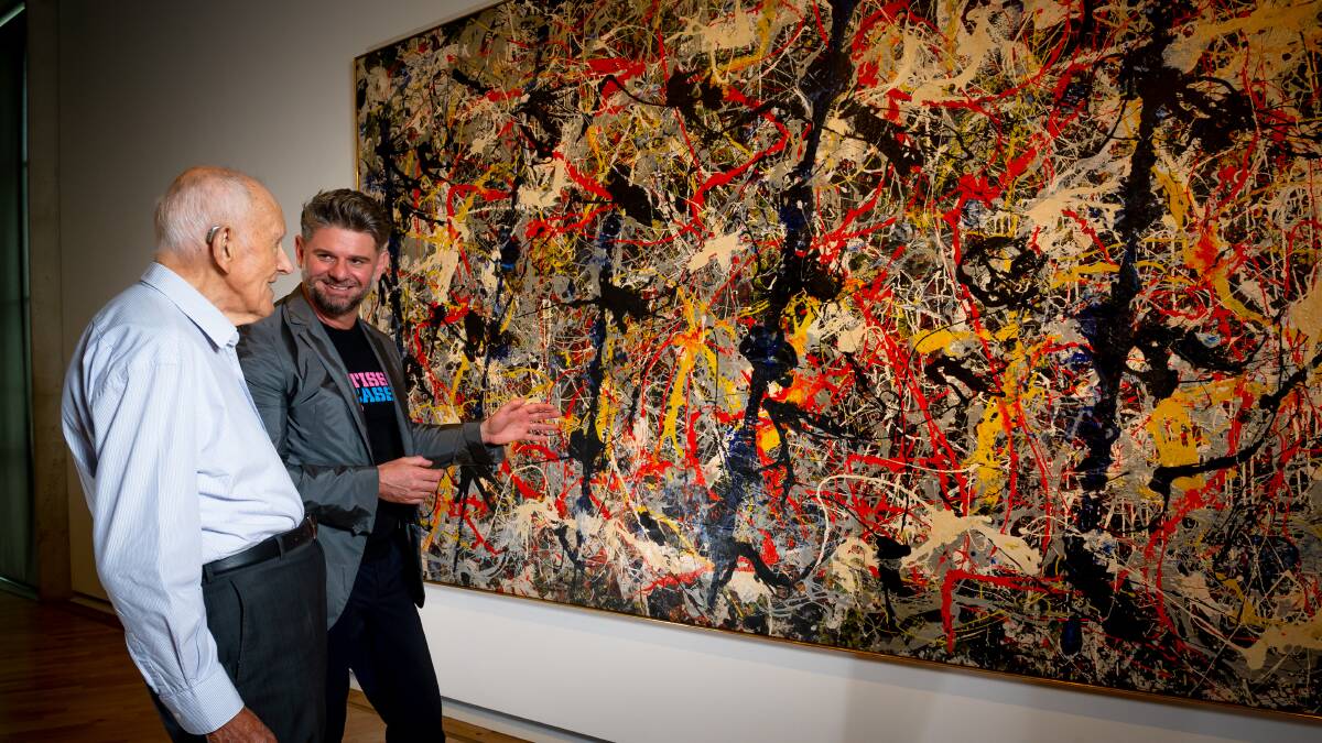 Current National Gallery of Australia director Nick Mitzevich, right, with Ted Crossing as the pair discuss the purchase of Blue Poles. Picture: Elesa Kurtz