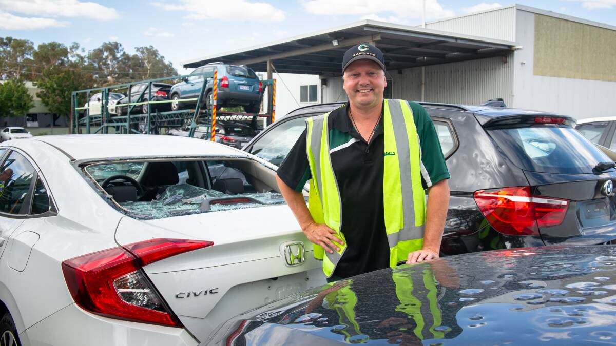 Carways' Scott Brown with hail-damaged cars waiting in Mitchell to be trucked out. Picture: Elesa Kurtz