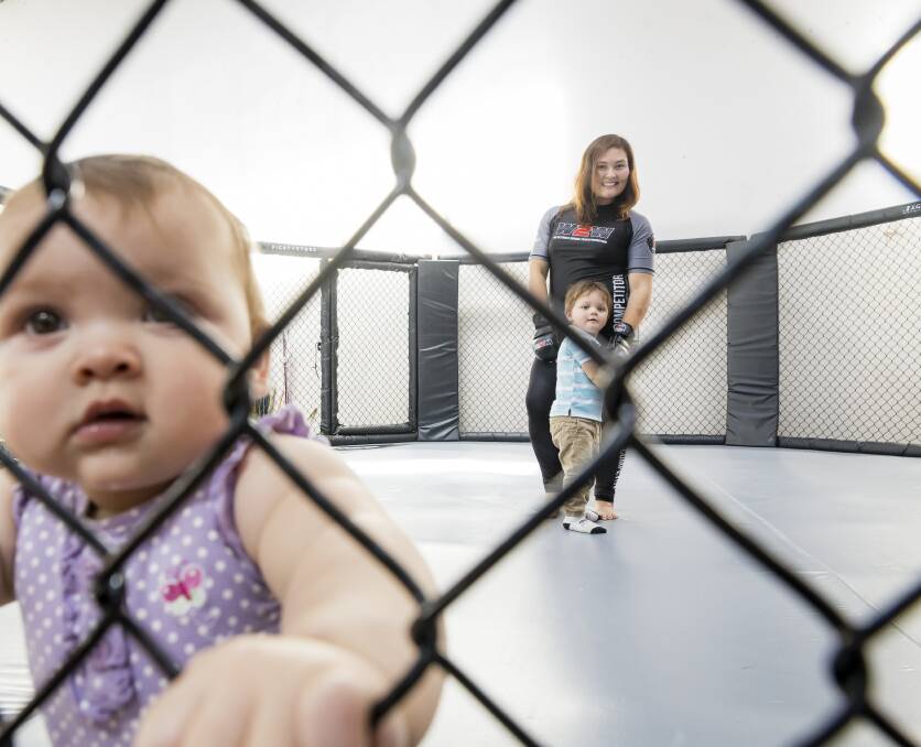 Canberra mum Sacha Stokes, in the cage with Marceline, 9 months, and Phoenix, 2. Picture: Sitthixay Ditthavong